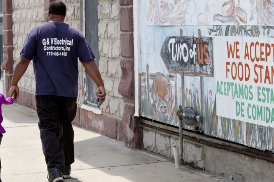 HARVEY, IL - AUGUST 19: A sign painted on top of a mural says 'We accept food stamps,' on August 19, 2013 in Harvey, Illinois. Harvey is a depressed suburb of Chicago that has been hit even harder by the sluggish economy. The suburban poor also have challenges getting services that can help them. Buildings all over town are boarded up - whether they be single family homes or businesses. (Photo by Melanie Stetson Freeman/The Christian Science Monitor via Getty Images)